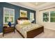 Stylish bedroom with tray ceiling, picture window, and a king-size bed with designer linens at 21221 Wacissa Dr, Venice, FL 34293