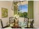 Cozy breakfast nook with a glass table, bamboo chairs, and bright green accents at 21221 Wacissa Dr, Venice, FL 34293