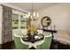 Elegant dining room with dark wood table, stylish chairs, and a decorative mirror at 21221 Wacissa Dr, Venice, FL 34293