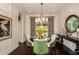 Formal dining room features a dark wood table, stylish decor, and ample natural light at 21221 Wacissa Dr, Venice, FL 34293