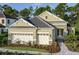Charming single-Gathering home featuring a well-manicured lawn, stone accents, and a spacious two-car garage at 21221 Wacissa Dr, Venice, FL 34293