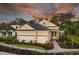 Inviting two-story home with a three-car garage, stone accents, and beautiful landscaping at 21221 Wacissa Dr, Venice, FL 34293