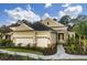 Beautiful home with a stone facade, lush landscaping, and a two-car garage, showcasing curb appeal at 21221 Wacissa Dr, Venice, FL 34293