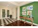 Welcoming foyer featuring checkered tile floors, a green accent wall, and elegant decor at 21221 Wacissa Dr, Venice, FL 34293