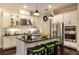 Stylish kitchen featuring stainless steel appliances, a center island with seating, and ample cabinet space at 21221 Wacissa Dr, Venice, FL 34293