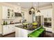 Gourmet kitchen features a large island, stainless steel appliances, and stylish pendant lighting at 21221 Wacissa Dr, Venice, FL 34293