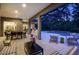 Spacious outdoor patio with a dining area, seating, and a view of the screened-in pool area at 21221 Wacissa Dr, Venice, FL 34293
