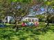 A vibrant backyard featuring a row of colorful chairs under a shady tree at 2340 Canal Dr # G-35, Bradenton, FL 34207