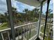 Scenic balcony view showcasing a community with lush greenery and tropical trees at 2340 Canal Dr # G-35, Bradenton, FL 34207