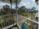 Scenic balcony showcasing the property's lush landscaping and tropical trees at 2340 Canal Dr # G-35, Bradenton, FL 34207