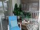 Relaxing balcony featuring lush plants, a cozy chair, and peaceful ambiance at 2340 Canal Dr # G-35, Bradenton, FL 34207