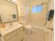 Bright bathroom features a shower-tub combo, ample vanity space, and tile flooring for easy maintenance at 2340 Canal Dr # G-35, Bradenton, FL 34207
