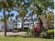 Lush common area with benches, tropical plants, and a view of the building at 2340 Canal Dr # G-35, Bradenton, FL 34207