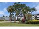 Condominium building featuring well-maintained lawns and tropical landscaping at 2340 Canal Dr # G-35, Bradenton, FL 34207