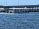 Gulf Island Ferry boat sails on shimmering water under a bridge at 2340 Canal Dr # G-35, Bradenton, FL 34207