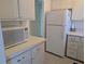 Efficient kitchen showcases white cabinets, white appliances, and durable countertops for a functional cooking space at 2340 Canal Dr # G-35, Bradenton, FL 34207