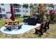 Outdoor community picnic area with shade umbrella, BBQ grill, and benches at 2340 Canal Dr # G-35, Bradenton, FL 34207