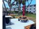 Outdoor community picnic area with grill, picnic table, and shade umbrella at 2340 Canal Dr # G-35, Bradenton, FL 34207