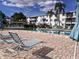 Relaxing poolside with lounge chairs and community pool with clear blue water at 2340 Canal Dr # G-35, Bradenton, FL 34207