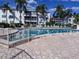 Sparkling community pool with lounge chairs and lush landscaping at 2340 Canal Dr # G-35, Bradenton, FL 34207