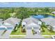 Stunning aerial perspective of the community with pristine homes surrounding a scenic lake at 2628 Sapphire Blue Ln, Bradenton, FL 34211