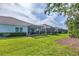 Well-maintained backyard featuring lush greenery and screened patios at 2628 Sapphire Blue Ln, Bradenton, FL 34211