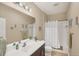 Bright bathroom featuring a shower-tub combo, large mirror, and modern vanity at 2628 Sapphire Blue Ln, Bradenton, FL 34211