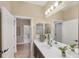 Bright bathroom with white countertop, dark cabinets, and a large mirror at 2628 Sapphire Blue Ln, Bradenton, FL 34211