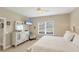 Bright bedroom with white furniture, a large window, and neutral decor creating a relaxing atmosphere at 2628 Sapphire Blue Ln, Bradenton, FL 34211