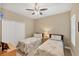 Cozy bedroom featuring two twin beds, floral-patterned bedding, and a ceiling fan at 2628 Sapphire Blue Ln, Bradenton, FL 34211
