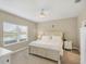 Bright bedroom featuring a large window, ceiling fan, and neutral decor at 2628 Sapphire Blue Ln, Bradenton, FL 34211