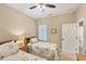 Cozy bedroom features two twin beds, a ceiling fan, and neutral wall color at 2628 Sapphire Blue Ln, Bradenton, FL 34211