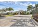 Community entrance showcasing lush landscaping and a well-maintained gatehouse, and paved entranceway at 2628 Sapphire Blue Ln, Bradenton, FL 34211