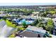 Aerial view of community pool, spa, and clubhouse with palm trees and water views at 2628 Sapphire Blue Ln, Bradenton, FL 34211