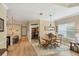 Charming dining room featuring a wood table, four chairs, and a modern light fixture, open to kitchen at 2628 Sapphire Blue Ln, Bradenton, FL 34211