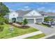 Charming home with gray roof, a well-kept lawn, tasteful landscaping, and brick driveway at 2628 Sapphire Blue Ln, Bradenton, FL 34211