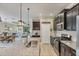 Kitchen featuring dark cabinets, granite countertops, an island, and stainless steel appliances, open to the living area at 2628 Sapphire Blue Ln, Bradenton, FL 34211