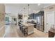 Bright kitchen with granite counters, an island with stools, and stainless steel appliances offering a functional cooking space at 2628 Sapphire Blue Ln, Bradenton, FL 34211