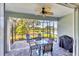 Screened lanai with patio furniture overlooking a serene pond and landscaping at 2628 Sapphire Blue Ln, Bradenton, FL 34211