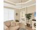 Comfortable living room showcases a tray ceiling and an open doorway to the bedroom at 2628 Sapphire Blue Ln, Bradenton, FL 34211