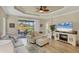 Comfortable living area with a view of a screened lanai overlooking a tranquil pond at 2628 Sapphire Blue Ln, Bradenton, FL 34211