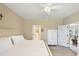 Spacious main bedroom with a ceiling fan, plush carpet, and bright, open doorways at 2628 Sapphire Blue Ln, Bradenton, FL 34211