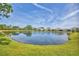 Large pond and landscaping are visible from the backyard in this beautiful water view home at 2628 Sapphire Blue Ln, Bradenton, FL 34211