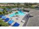 A bird's eye view showcases the stunning pool, a peaceful lake, and inviting lounge areas, promising a relaxing lifestyle at 2628 Sapphire Blue Ln, Bradenton, FL 34211