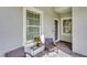 Cozy front porch with decorative tile flooring, seating, and a view of the entrance at 2628 Sapphire Blue Ln, Bradenton, FL 34211