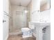 This bathroom features a stand up shower with glass doors and a white pedestal sink at 2703 Avenue B, Holmes Beach, FL 34217