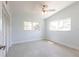 Bright bedroom featuring neutral carpet and ceiling fan, complemented by light blue walls at 2703 Avenue B, Holmes Beach, FL 34217
