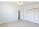 Bright bedroom featuring neutral carpet and ceiling fan, complemented by light blue walls at 2703 Avenue B, Holmes Beach, FL 34217
