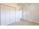 Bedroom featuring neutral carpet and ceiling fan with a large closet at 2703 Avenue B, Holmes Beach, FL 34217
