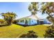 Charming single-story home with well-maintained lawn, mature trees, and a delightful, screened porch at 2703 Avenue B, Holmes Beach, FL 34217